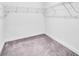 Walk-in closet with neutral carpet, wire shelving, and white walls in the home at 5672 Jonesboro Ave, North Port, FL 34288