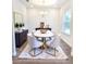 Modern dining room with neutral chairs, marble table, stylish decor, and hardwood floors at 5672 Jonesboro Ave, North Port, FL 34288