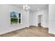 Bright and airy dining room featuring hardwood floors and natural light from a window at 5672 Jonesboro Ave, North Port, FL 34288
