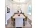 Elegant dining room with a long wooden table, six chairs, and a contemporary chandelier at 5672 Jonesboro Ave, North Port, FL 34288