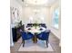Contemporary dining room featuring blue chairs, marble table, modern decor, and hardwood floors at 5672 Jonesboro Ave, North Port, FL 34288