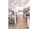 Modern kitchen boasts stainless steel appliances, granite countertops, a central island, and ample cabinet space at 5672 Jonesboro Ave, North Port, FL 34288