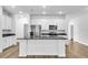 Bright kitchen with stainless steel appliances, granite countertops, white cabinets, and a center island with a sink at 5672 Jonesboro Ave, North Port, FL 34288