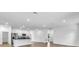 Open-concept kitchen with stainless steel appliances, granite countertops, white cabinets, and lots of natural light at 5672 Jonesboro Ave, North Port, FL 34288
