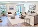 Cozy living room with a modern farmhouse design, bright lighting, and warm wood flooring at 5672 Jonesboro Ave, North Port, FL 34288