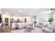 Spacious open-concept living room with abundant natural light, neutral decor, and wood flooring at 5672 Jonesboro Ave, North Port, FL 34288