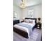 Elegant main bedroom features a luxurious bed with stylish decor and ample natural light at 5672 Jonesboro Ave, North Port, FL 34288