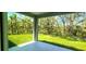 Lush backyard view from a covered patio, offering serene outdoor living at 5672 Jonesboro Ave, North Port, FL 34288