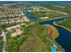 Stunning aerial view of a residential community with beautiful waterfront properties and lush greenery at 5821 Valente Pl, Sarasota, FL 34238