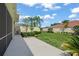 Lush backyard with green grass, mature trees, and privacy hedges at 5821 Valente Pl, Sarasota, FL 34238