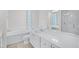 Bright bathroom featuring double sinks, a bathtub, a separate shower, and natural light at 5821 Valente Pl, Sarasota, FL 34238