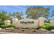 Monumental community entrance featuring professional landscaping and impressive signage at VillageWalk on Palmer Ranch at 5821 Valente Pl, Sarasota, FL 34238