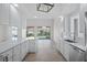 Spacious kitchen with sleek countertops, stainless steel appliances, and backyard views at 5821 Valente Pl, Sarasota, FL 34238