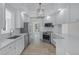 Contemporary kitchen boasts stainless steel appliances, quartz countertops, and ample natural light at 5821 Valente Pl, Sarasota, FL 34238
