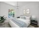 Relaxing bedroom with ensuite bathroom and views of the lush exterior at 5821 Valente Pl, Sarasota, FL 34238