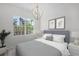 Cozy bedroom with a large window offering plenty of natural light and outside views at 5821 Valente Pl, Sarasota, FL 34238