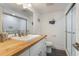 Well-lit bathroom features a wood countertop, glass shower, and nautical decor at 601 Gulf S Dr, Bradenton Beach, FL 34217