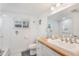 Bright bathroom featuring a wood countertop, white cabinets, and a modern sink at 601 Gulf S Dr, Bradenton Beach, FL 34217