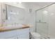 Clean and bright bathroom with glass shower doors and a wood countertop at 601 Gulf S Dr, Bradenton Beach, FL 34217