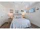 Bright bedroom with nautical decor, two windows, and wood look tile flooring at 601 Gulf S Dr, Bradenton Beach, FL 34217