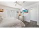 Bright bedroom featuring balcony access and a decorative dresser with mirror and wall-mounted television at 601 Gulf S Dr, Bradenton Beach, FL 34217