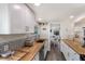 Bright and functional kitchen featuring butcher block counters, white cabinets, and a stylish tile backsplash for a modern look at 601 Gulf S Dr, Bradenton Beach, FL 34217