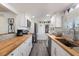 Well-lit kitchen with stainless steel appliances, butcher block countertops, and white cabinetry for a modern and functional space at 601 Gulf S Dr, Bradenton Beach, FL 34217