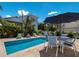 Stunning pool, outdoor dining area and lush vegetation for privacy at 601 Gulf S Dr, Bradenton Beach, FL 34217