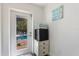 Entry room from pool area features a stack of towels, a mini fridge, and door to the pool at 601 Gulf S Dr, Bradenton Beach, FL 34217