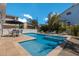 Backyard pool area features travertine tile, seating, and lush greenery at 601 Gulf S Dr, Bradenton Beach, FL 34217