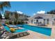 Gorgeous pool with built in hot tub, travertine tile, and outdoor dining area at 601 Gulf S Dr, Bradenton Beach, FL 34217