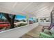Wrap-around porch with multiple seating areas, offering an outdoor view of the ocean and the road at 601 Gulf S Dr, Bradenton Beach, FL 34217