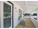 Inviting front porch with seating offers relaxing space with views to beach and neighborhood at 601 Gulf S Dr, Bradenton Beach, FL 34217