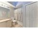 Bright bathroom featuring a vanity, toilet, and shower/tub combination with a floral shower curtain at 6106 New Paris Way, Ellenton, FL 34222