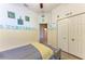 Bedroom featuring nautical decor, laminate flooring, and a view of the closet at 6106 New Paris Way, Ellenton, FL 34222
