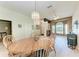 Open concept dining room with wood table and chandelier lighting at 6106 New Paris Way, Ellenton, FL 34222