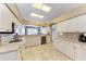 Traditional kitchen features tile flooring, countertops, white cabinets, and stainless steel appliances at 6106 New Paris Way, Ellenton, FL 34222