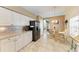 Eat-in kitchen features granite counters, white cabinets, tiled backsplash, and a stainless steel refrigerator at 6106 New Paris Way, Ellenton, FL 34222