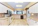 Kitchen featuring white cabinets, tile floors, and open concept floor plan at 6106 New Paris Way, Ellenton, FL 34222