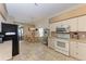 Kitchen features granite counters, tiled floors, white cabinets, stainless steel appliances, and a breakfast nook at 6106 New Paris Way, Ellenton, FL 34222