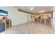 Open living room with tile flooring, bar seating area, neutral paint, and a ceiling fan at 6106 New Paris Way, Ellenton, FL 34222