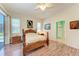 Main bedroom featuring wood-look floors, ceiling fan, and ensuite bathroom at 6106 New Paris Way, Ellenton, FL 34222