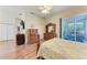 Bedroom featuring wood-look floors, ceiling fan, and sliding glass door at 6106 New Paris Way, Ellenton, FL 34222
