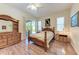 Main bedroom featuring wood-look floors, ceiling fan, and sliding glass door at 6106 New Paris Way, Ellenton, FL 34222