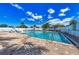 Community pool with lounge chairs and a beautiful blue sky, perfect for relaxation and socializing at 6106 New Paris Way, Ellenton, FL 34222