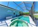 Relaxing pool and hot tub within a screened lanai offers perfect outdoor entertaining at 6106 New Paris Way, Ellenton, FL 34222