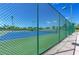 Tennis court with a green fence, offering a great outdoor activity for residents at 6106 New Paris Way, Ellenton, FL 34222