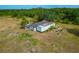 Aerial view of a mobile home on a large lot featuring mature trees, and lush landscaping at 6321 279Th E St, Myakka City, FL 34251