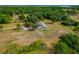Expansive aerial view of the property, including mature trees, lush lawns and surrounding greenery at 6321 279Th E St, Myakka City, FL 34251