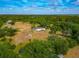 Expansive aerial view of the property, including mature trees, lush lawns and surrounding greenery at 6321 279Th E St, Myakka City, FL 34251